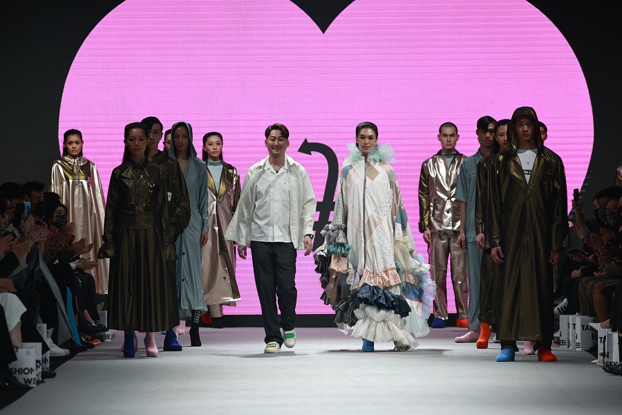 Models catwalking with pink heart backgound at the Taipei Fashion Week AW21